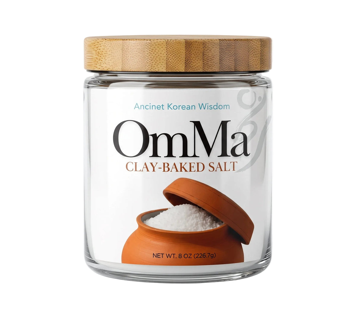 A jar of OmMa Clay-Baked Salt on a plain white background. The product is in a clear glass jar with a light brown bamboo-style lid and a white label featuring the brand name 'OmMa' and an illustration of a clay pot containing white salt.

OmMa salt. clay-baked mineral rich sea salt from South Korea. Corse mineral rich sea salt in 8 oz glass jar premium artisan salt no chemicals or machinery 6 times more minerals than table salt low sodium hand-harvested, hand-raked. 